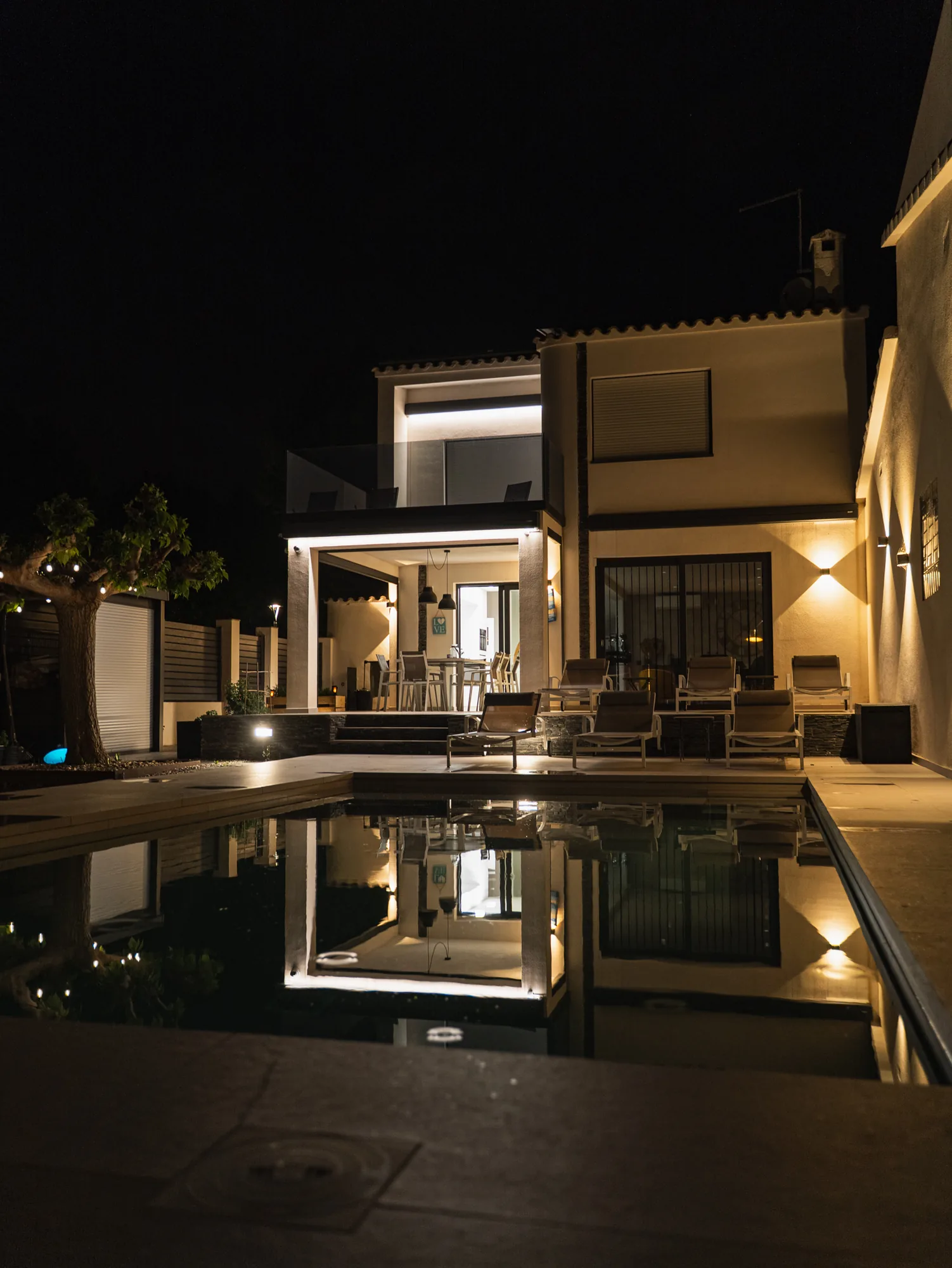 Vue nocturne de la villa et de sa piscine illuminée